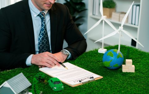 Businessman or CEO in office signing environmental regulation. Quaint