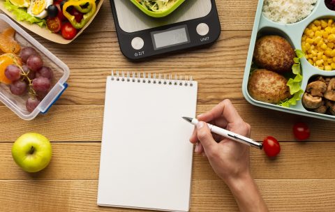 top-view-tasty-meal-arrangement-with-empty-notebook